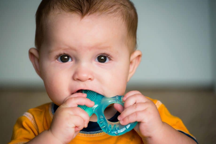 baby chewing on teething ring