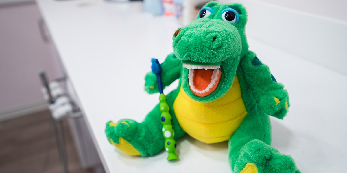 stuffed alligator toy with toothbrush